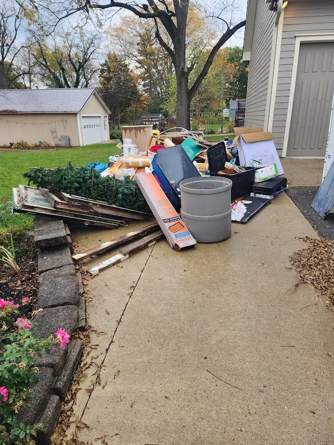 Dumpster being loaded with debris for Residential Dumpster Rental in Madera